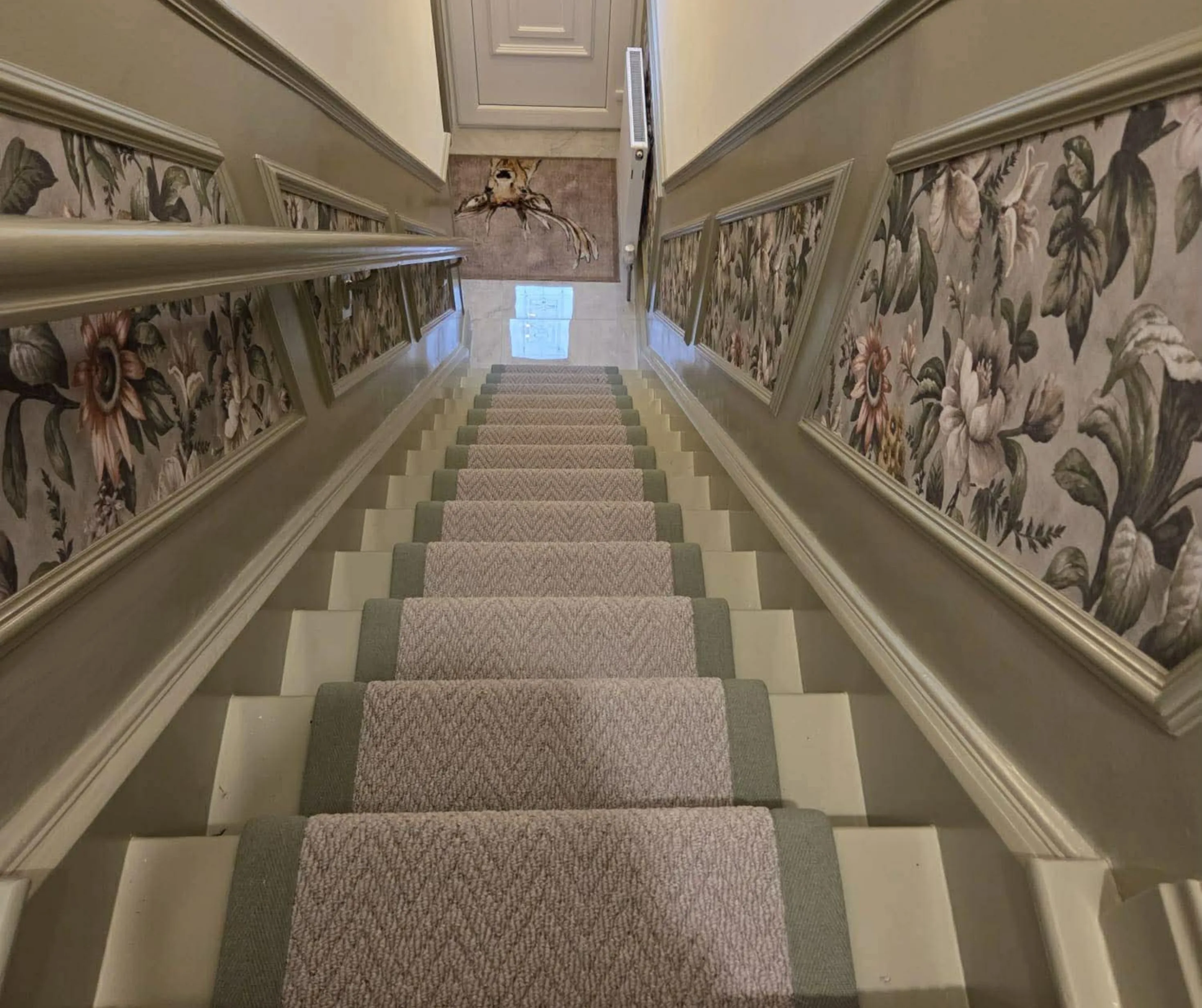 A herringbone stair runner fitted to a staircase in a Colne home, late afternoon light on the treads