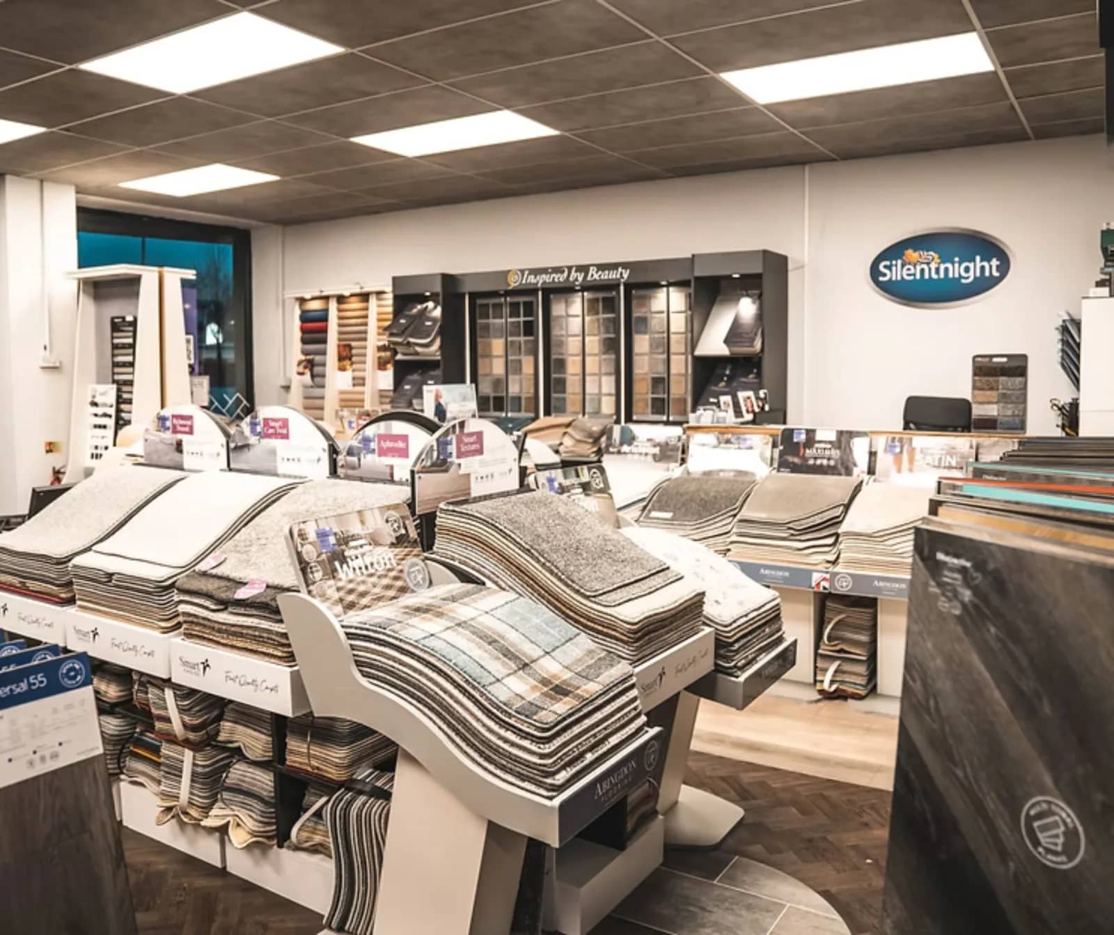 Carpet sample stands and bed displays on the Boundary Carpets and Beds showroom floor in Colne